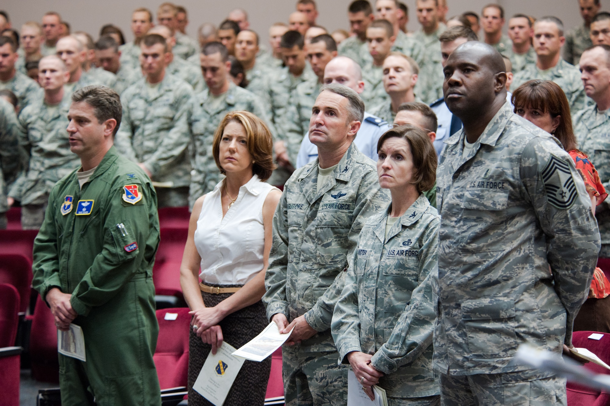 The audience stands during a Holocaust Days of Remembrance commemoration event held April 18 at the Officer Training School. Attendees included, front row from left, Col. David Cohen, the Air University’s director of staff; Sandi Killough, spouse of 42nd Air Base Wing commander Col. Brian Killough; Col. Thomas Coglitore, OTS commander, Col. Susan Schlacter, 42nd Air Base Wing vice commander and Chief Master Sgt. Cornell Johnson, 42nd Medical Group superintendent. (Air Force photo by Melanie Rodgers Cox)