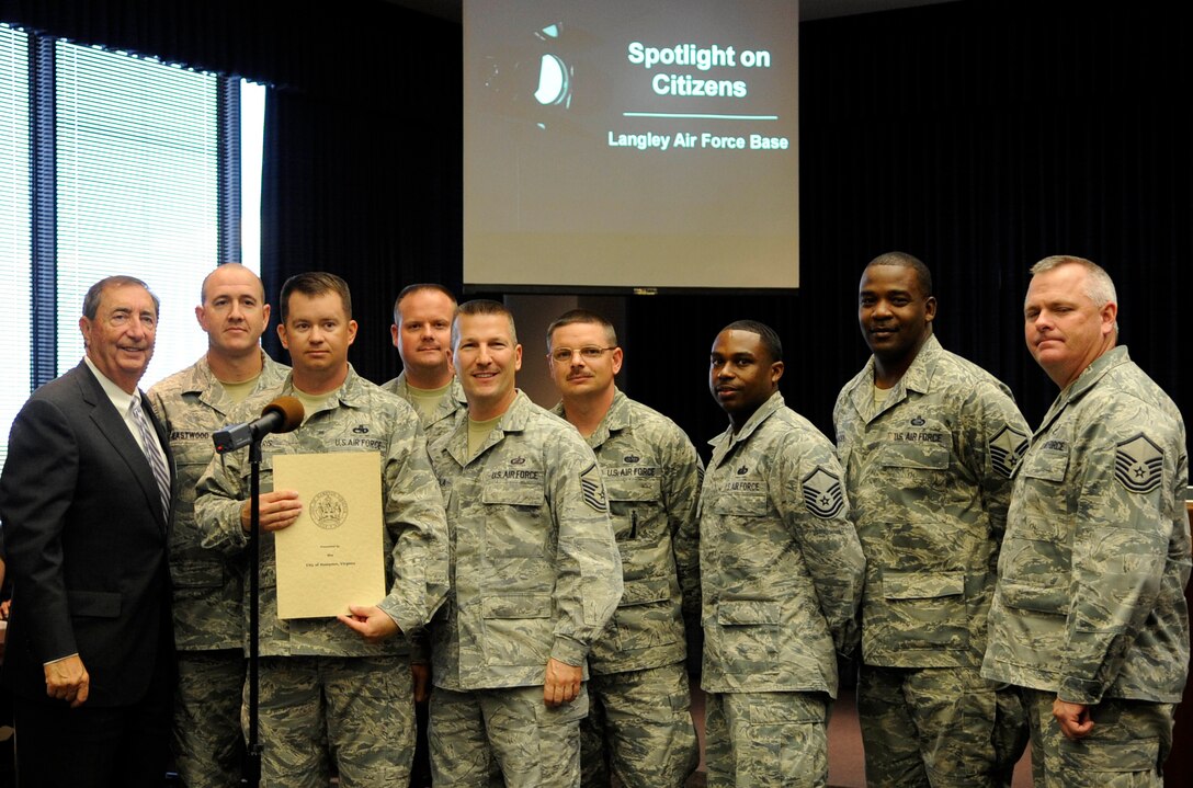 Members of the Air Combat Command Inspector General office pose for a photo with Joseph Spencer, city of Hampton council member during the Meals on Wheels volunteer recognition ceremony at Hampton City Hall, Hampton, Va., April 25, 2012. Spencer and other members of the City of Hampton City Council honored the team with a proclamation that recognized the Airmen for their service in support of the Peninsula Agency on Aging, Meals on Wheels program. The IG team has accumulated more than 1,050 volunteer hours resulting in 4,200 meals delivered in support of more than 700 homebound Peninsula seniors, yearly. (U.S. Air Force photo by Staff Sgt. Dana Hill/Released)