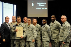 Members of the Air Combat Command Inspector General office pose for a photo with Joseph Spencer, city of Hampton council member during the Meals on Wheels volunteer recognition ceremony at Hampton City Hall, Hampton, Va., April 25, 2012. Spencer and other members of the City of Hampton City Council honored the team with a proclamation that recognized the Airmen for their service in support of the Peninsula Agency on Aging, Meals on Wheels program. The IG team has accumulated more than 1,050 volunteer hours resulting in 4,200 meals delivered in support of more than 700 homebound Peninsula seniors, yearly. (U.S. Air Force photo by Staff Sgt. Dana Hill/Released)
