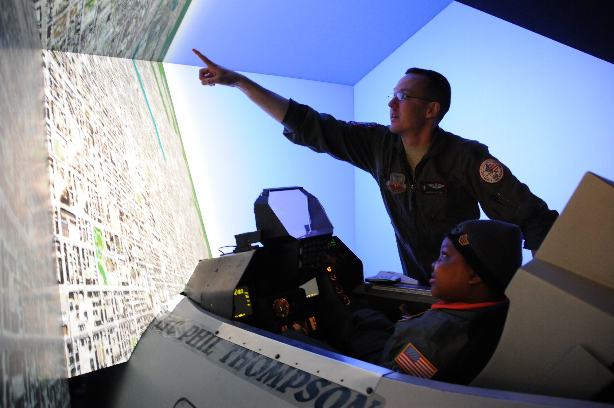 Darion Thorne, dressed as a major general, learns about pilot training in a flight simulator from the 121st Fighter Squadron during a day in which Darion was appointed a pilot for the Pilot for a Day program, April 26, 2012. Darion is a terminally ill child diagnosed with Diffuse Intrinsic Pontine Glioma, which is a tumor on the brain stem. (U.S. Air Force photo/ Tech. Sgt. Craig Clapper)