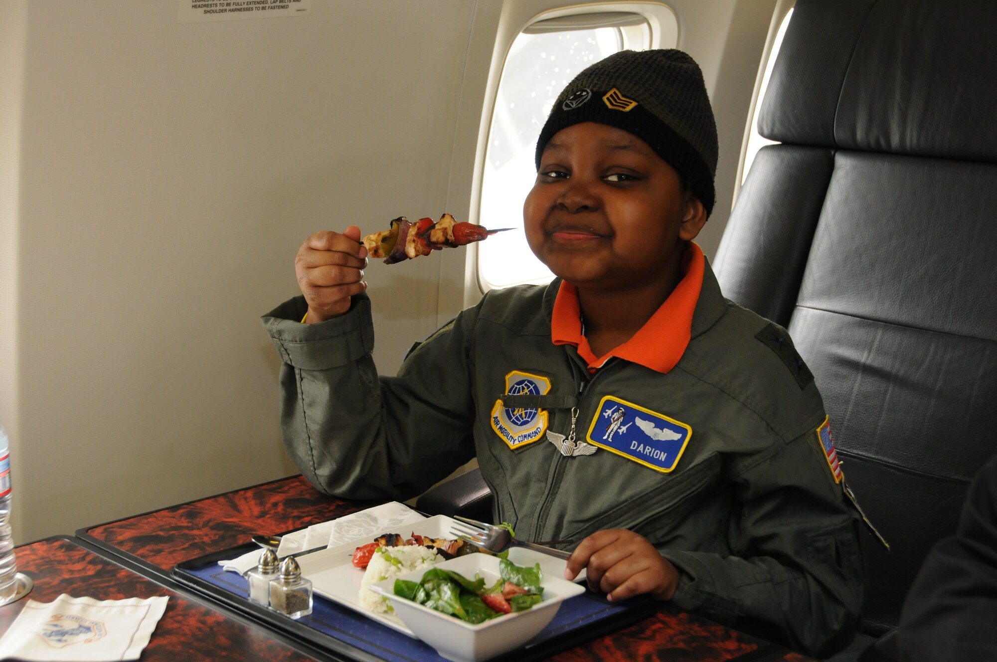 Darion Thorne, dressed as a major general, enjoys some of his favorite foods while on-board a C-30 aircraft from the 201st Airlift Squadron during a day in which Darion was appointed a pilot for the Pilot for a Day program, April 26, 2012. Darion is a terminally ill child diagnosed with Diffuse Intrinsic Pontine Glioma, which is a tumor on the brain stem. (U.S. Air Force photo/ Senior Airman Katie Spencer)