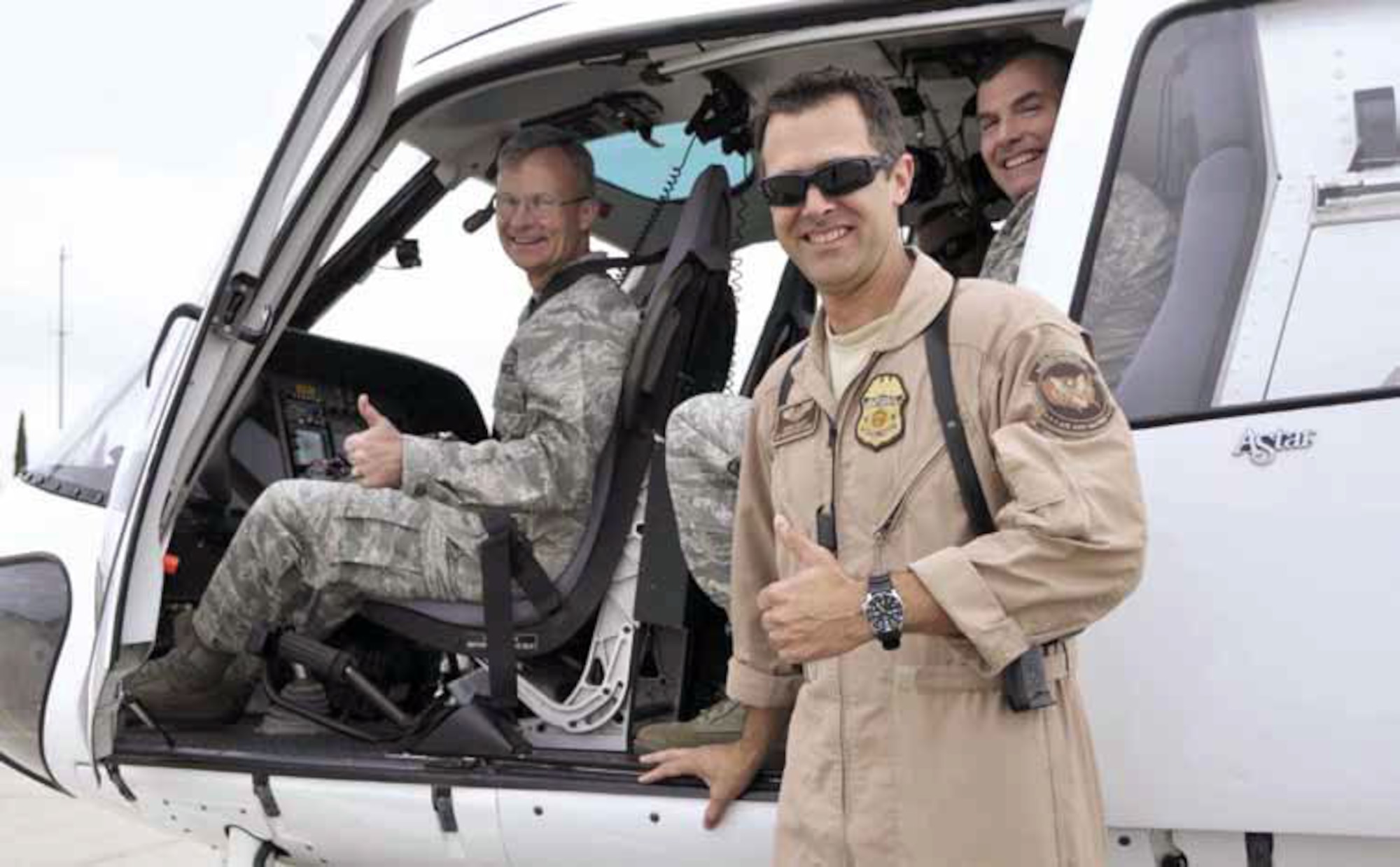 Maj. Gen. Steven J. Lepper, Deputy Judge Advocate General, HQ USAF, accompanied by Col. Jeffrey P. Wilcox, Staff Judge Advocate, HQ AFRC/JA and Chief Master Sgt. Steven L Wallace, Senior paralegal manager to the Judge Advocate General, HQ USAF, prepare to take-off on a helicopter flight piloted by Air Interdiction Agent, Derrick Block, U.S. Customs and Border Protection. (U.S. Air Force photo by Darnell Gardner)