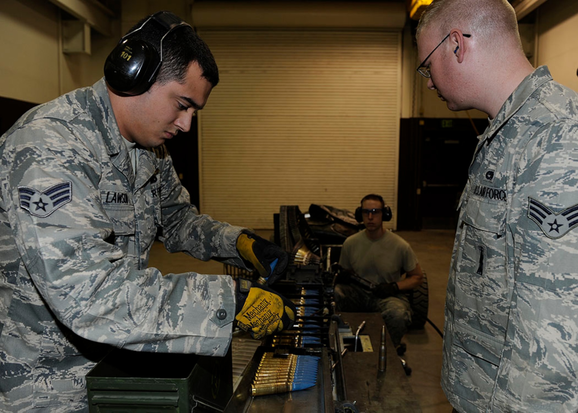 Members of the 3rd Munitions Squadron Conventional Maintenance use an ammunition loading system replenisher assembly to load 20-milimeter rounds into a universal ammunition loading system on Joint Base Elmendorf-Richardson, Alaska, April 26. The rounds will be used by F-22s to fire at a target banner during aerial combat training. (U.S. Air Force photo/Staff Sgt. Robert Barnett)