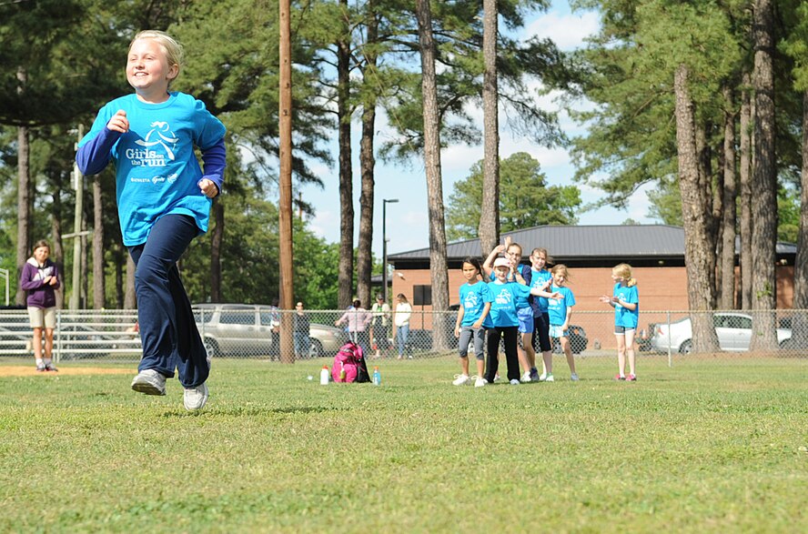 Jadyn Lucey runs away from her Girls on the Run teammates on Seymour Johnson Air Force Base, N.C., April 24, 2012. GOTR is a non-profit program that encourages girls to build self-respect and healthy lifestyles through exercise and teamwork. Jadyn is the daughter of Lt. Col. Craig Lucey, 4th Training Squadron commander, and hails from Anchorage, Alaska. (U.S. Air Force photo/Airman 1st Class Aubrey Robinson/Released)