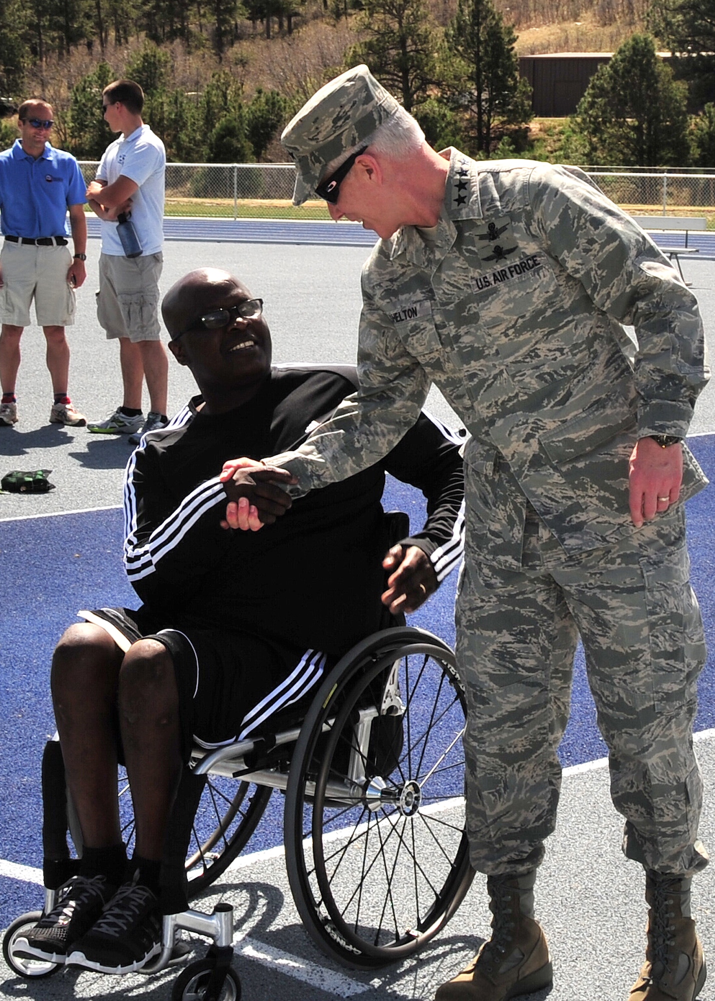 Gen. William L. Shelton, Commander, Air Force Space Command, talks with the coach of the Air Force wheelchair basketball team, Willie Jackson, Paralympic Sports Program, during the Warrior Games training week at the U.S. Air Force Academy, Colo. April 25. The U.S. Olympic Committee and DoD strongly believe in the role of sport in everyone’s life as having great potential for building not just the body, but the mind and spirit as well. (U.S. Air Force photo/Duncan Wood)