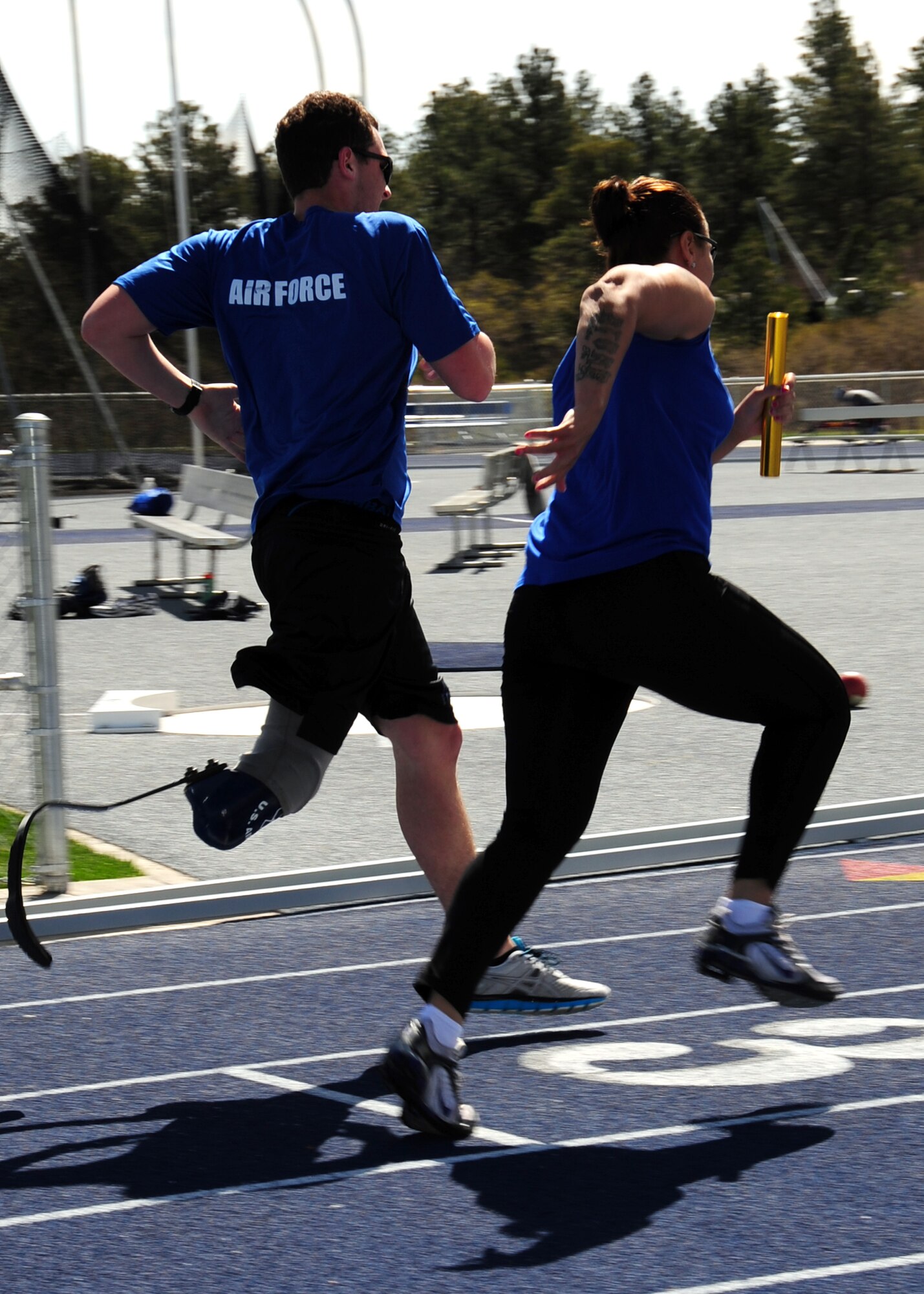 Retired Senior Airman Jennifer Stone takes the baton from 1st Lt. Ryan McGuire in a relay race during the Warrior Games at the U.S. Air Force Academy, Colo. April 25. The U.S. Olympic Committee and DoD strongly believe in the role of sport in everyone’s life as having great potential for building not just the body, but the mind and spirit as well. (U.S. Air Force photo/Duncan Wood)