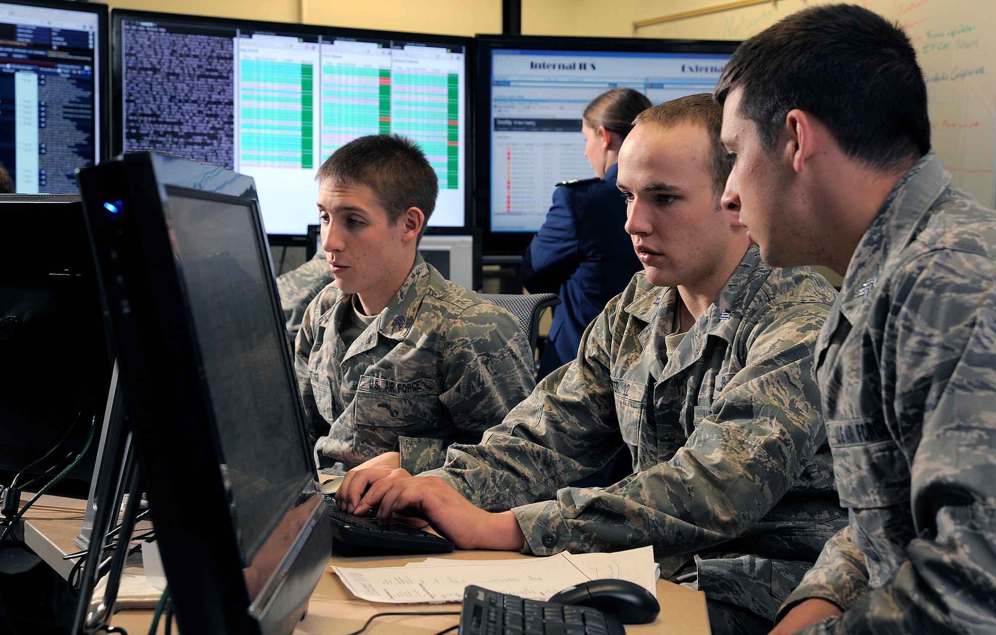 Cadet 1st Class Jordan Keefer, center, coordinates cadet efforts to defend their network during the National Security Agency's Cyber Defense Exercise April 17, 2012. The Air Force Academy team took first place in the competition, outscoring the other U.S. service academies as well as two post-graduate Air Force Institute of Technology teams. (U.S. Air Force photo/Raymond McCoy)