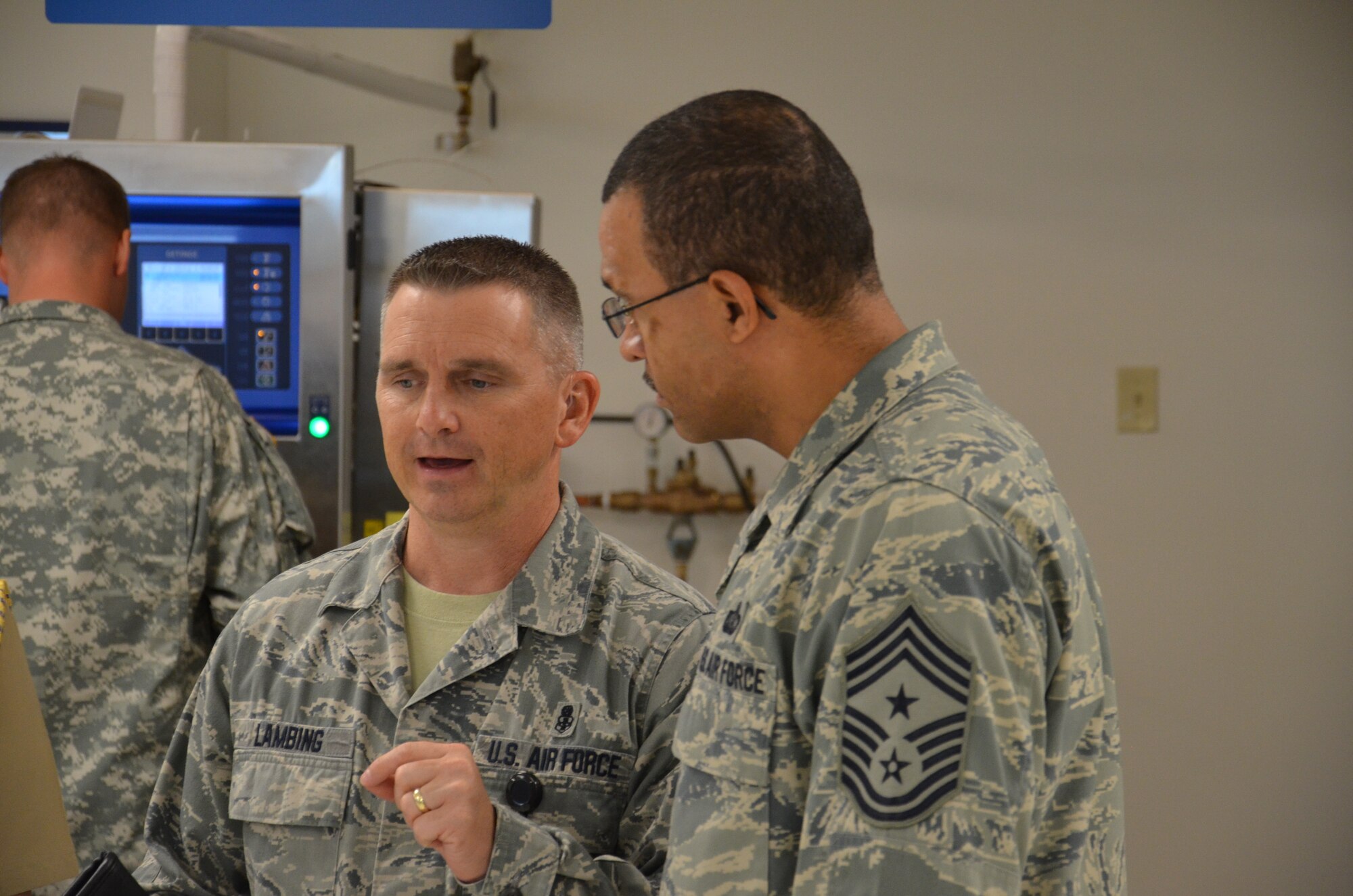 Chief Master Sgt. Kevin Lambing (left) discusses the operations of the Medical Education and Training Campus with another command chief at Fort Sam Houston, Texas, recently. Lambing was inducted into the Army's Order of the Military Medical Merit April 20. He was the command chief of the METC and is slated become the chief of the Air Force Medical Enlisted Force in the Office of the Surgeon General. (U.S. Army photo)