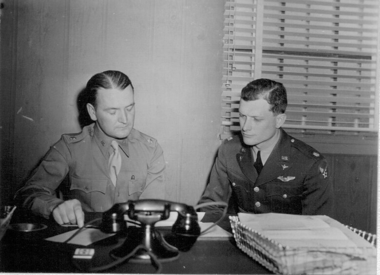 The first commander of Colorado Springs Army Air Base, Lt. Col. David Hutchison, and his second-in-command, Maj. Charles Hollstein, look over base construction plans in 1942. Both Hutchison and Hollstein would go on to command combat units overseas during World War II. (U.S. Air Force photo)