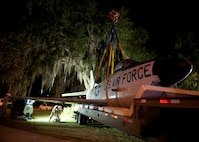 An F-86L Sabre rests on a flatbed trailer padded with mattresses in Valdosta, Ga. on April 24, 2012. Airmen from Moody Air Force Base coordinated with city officials and family of the late Maj. Lyn McIntosh, a Valdosta native killed during a rescue attempt in Iran in 1980.  After refurbishment, the aircraft will be displayed in the George W. Bush Air Park at Moody Field. (U.S. Air Force photo by Senior Airman Eileen Meier/Released)