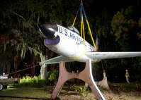 An F-86L Sabre is lifted off its mount in downtown Valdosta, Ga., and onto a flatbed trailer April 24, 2012. The historic aircraft is being moved to Moody Air Force Base, Ga., where it will be restored and displayed at the George W. Bush Air Park at Moody Field. (U.S. Air Force photo by Senior Airman Eileen Meier/Released)