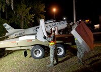 Airmen from Moody Air Force Base, Ga., place mattresses onto a flatbed trailer before moving the F-86L Sabre to Moody Air Force Base, Ga., April 24, 2012. The aircraft, which spent decades on display at the corner of Ashley Street and Woodrow Wilson Drive, will undergo an extensive refurbishment before being put on permanent display at George W. Bush Air Park at Moody Field. (U.S. Air Force photo by Senior Airman Eileen Meier/Released)