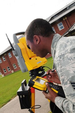 RAF MILDENHALL, England – Senior Airman Erik Holloman, 100th Civil Engineer Squadron Geobase flight, looks through the viewer of a total station (surveying equipment) April 16, 2012, to ensure it is lined up with the prism outside Building 680. Holloman and other geobase members use the global positioning system equipment to plot longitude and latitude, and coordinates for items such as fire hydrants or shrubs. Knowing the location of certain points is useful when buildings or other facilities are being designed. (U.S. Air Force photo/Karen Abeyasekere)