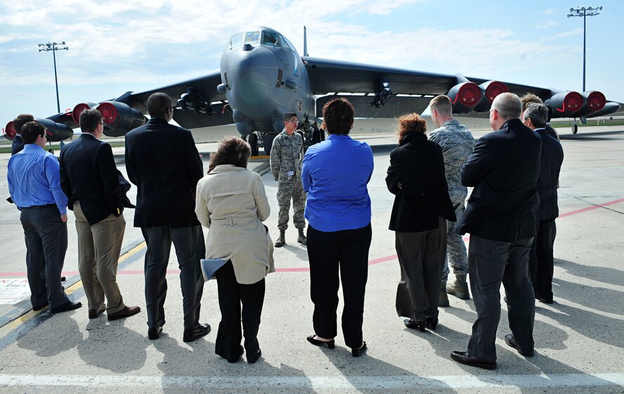 MINOT AIRFORCE BASE, N.D.  - - Senior Airman Jaime Torres, 5th Aircraft Maintenance Squadron crew chief, gives a tour of a B-52 static display during a Rating Agency visit, here April 25. The tour was to assess the value of the loan that will make housing privatization possible. (U.S. Air Force photo by Senior Airman Desiree W. Esposito)