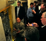 MINOT AIRFORCE BASE, N.D.  - - Tech Sgt. Javier Martinez, 91st Maintenance Operations Squadron trainer maintainer, gives a U-1 launch control trainer briefing to the Rating Agency visitors, here April 25. The tour was to assess the value of the loan that will make housing privatization possible. (U.S. Air Force photo by Senior Airman Desiree W. Esposito)