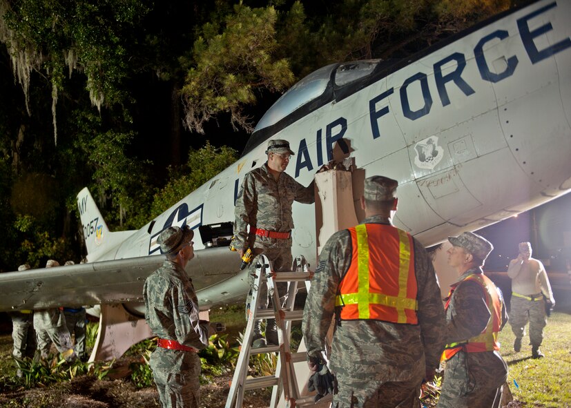 Airmen from Moody Air Force Base, Ga., survey the F-86L Sabre before moving it to Moody Field April 24, 2012. The aircraft is being moved from Woodrow Wilson Drive to Moody Air Force Base, Ga., where it will be restored and appropriately displayed within the George W. Bush Air Park at Moody Field along with the memorial to Maj. Lyn McIntosh.  The McIntosh family will be a part of the re-dedication ceremony for the aircraft. (U.S. Air Force photo by Senior Airman Eileen Meier/Released)