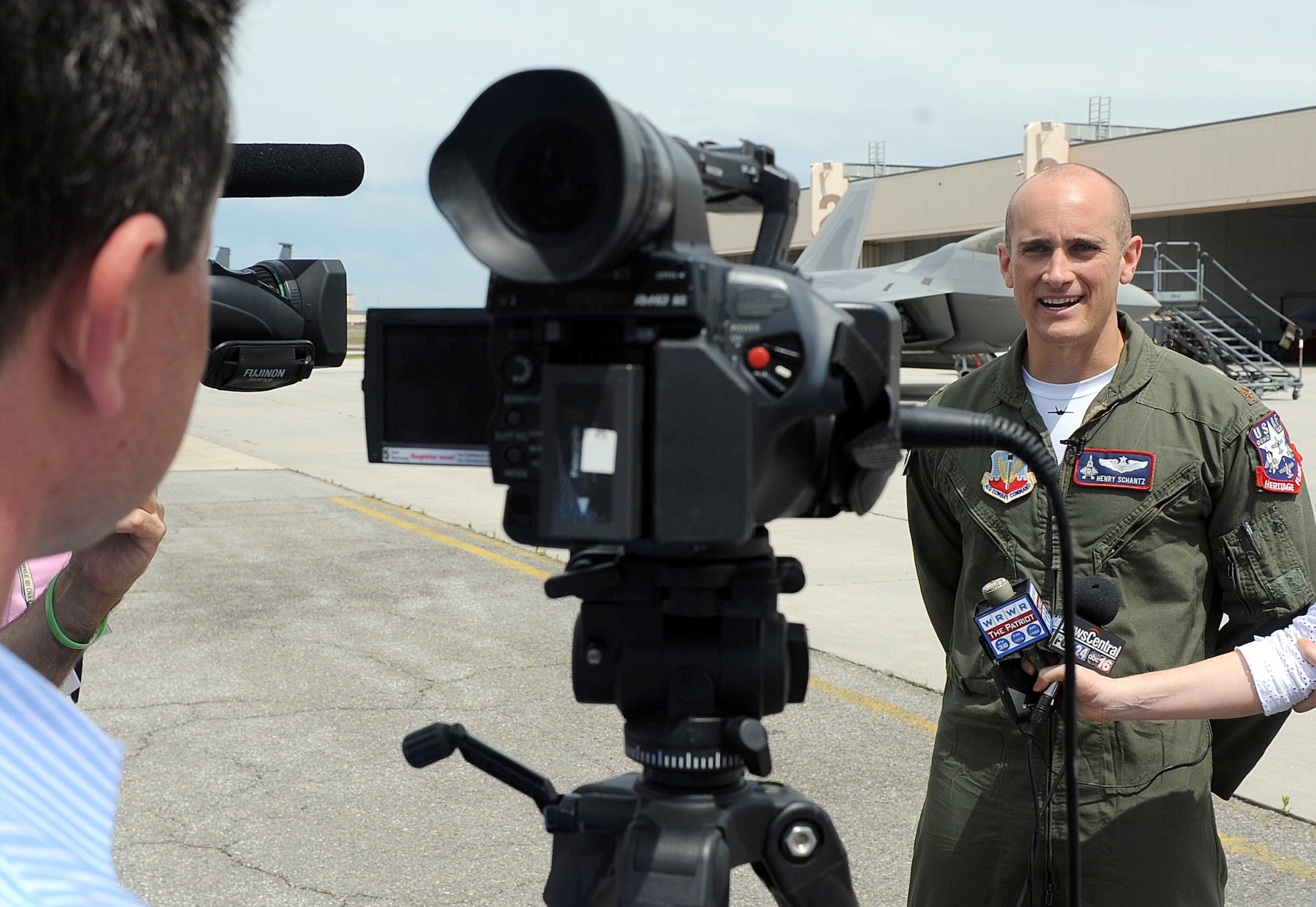 Maj. Henry Schantz speaks to local media about the F-22 Raptor, which will perform in the upcoming air show. The F-22 Raptor is the Air Force’s newest fighter aircraft. Its combination of stealth, supercruise, maneuverability, and integrated avionics, coupled with improved supportability, represents an exponential leap in warfighting capabilities. (U.S. Air Force photo by Tommie Horton)