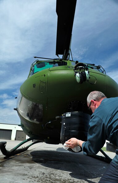 MINOT AIRFORCE BASE, N.D.  - - Civ. Shannon Reynolds, 54th Helicopter Squadron aircraft mechanic, performs post flight procedures on a UH-1N Huey, here April 24. Daily inspections on the helicopters are performed before and after each flight to maintain missile security. (U.S. Air Force photo by Senior Airman Desiree W. Esposito)