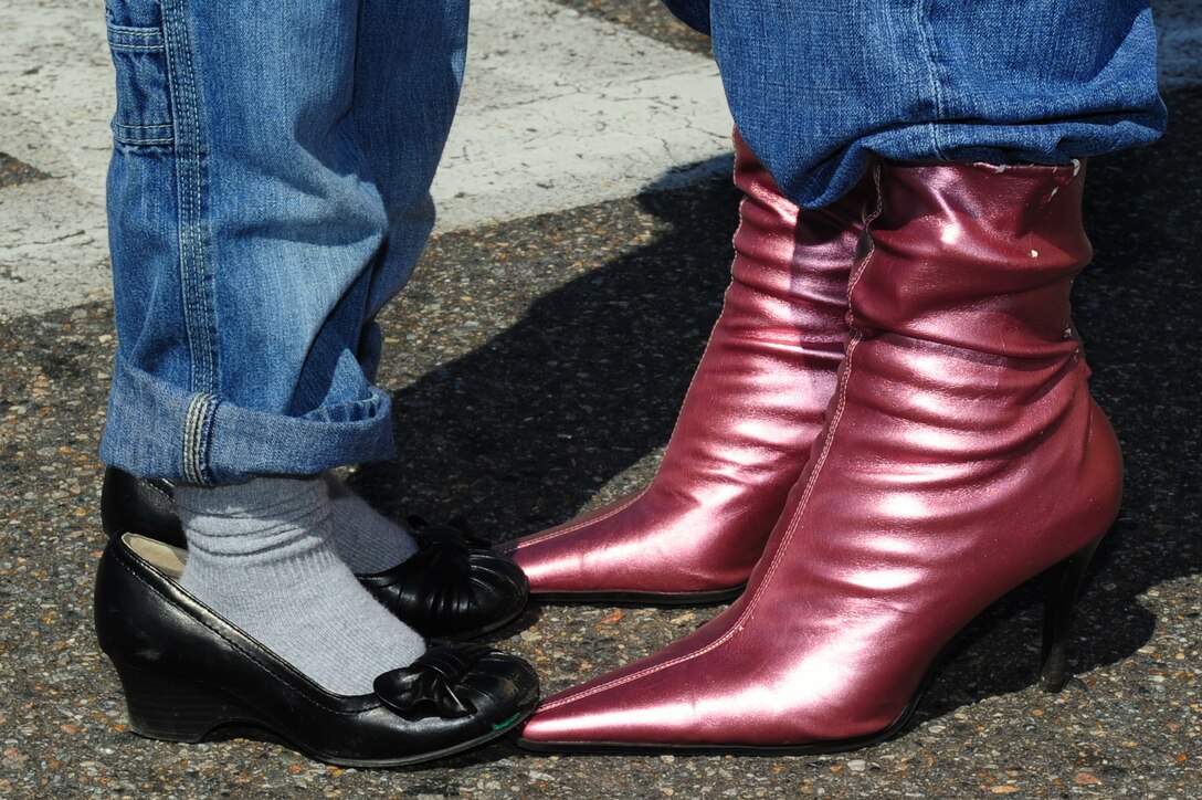 U.S. Air Force Staff Sgt. Garrett Eckert, right, 633rd Communications Squadron network integration craftsmen, and his son Corbin Eckert, age 3, participate in the annual “Walk a Mile in Her Shoes” event through Hampton, Va., April 14, 2012. The international men’s march is designed to stop rape, sexual assault and gender-based violence.  (U.S. Air Force photo by Airman 1st Class Kayla Newman/Released)