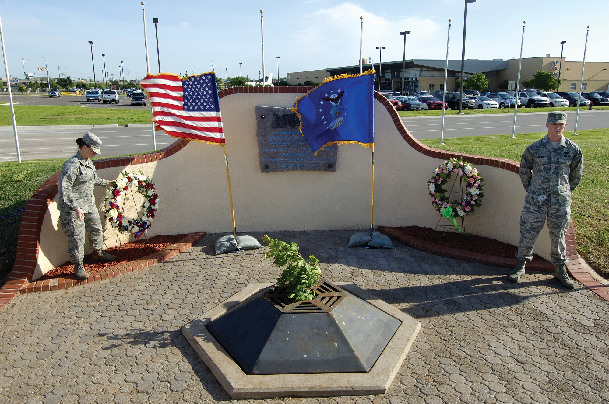 Airman 1st Class Kenneth Leeper, 3rd Combat Communications Group, stands by the wreath he placed for Airman 1st Class Cartney Jean McRaven of the 32nd Combat Communications Squadron as Airman 1st Class Heather Wallace, 72nd Medical Group, places a wreath honoring Airman 1st Class Lakesha Richardson Levy, 72nd Medical Support Squadron, during an April 19 ceremony at Tinker’s Oklahoma City Alfred P. Murrah bombing memorial. The ceremony was dedicated to the two Airmen and 166 others who died 17 years ago. Tinker’s Airmen were in the Social Security office when the building was attacked. Remembrance attendees included military and civilians who paid their respects observing 168 seconds of silence, one for each victim. (Air Force photo by Margo Wright)