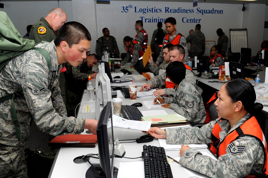 U.S. Air Force Staff Sgt Meliza Duplantis, right, 35th Medical Support Squadron pharmacy technician, processes Airman Harper Le, 35th Aircraft Maintenance Squadron, through the personnel deployment function line portion of an operational readiness exercise at Misawa Air Base, Japan, April 27, 2012. This is Misawa’s first ORE of 2012. (U.S. Air Force photo by Tech. Sgt. Marie Brown/Released)