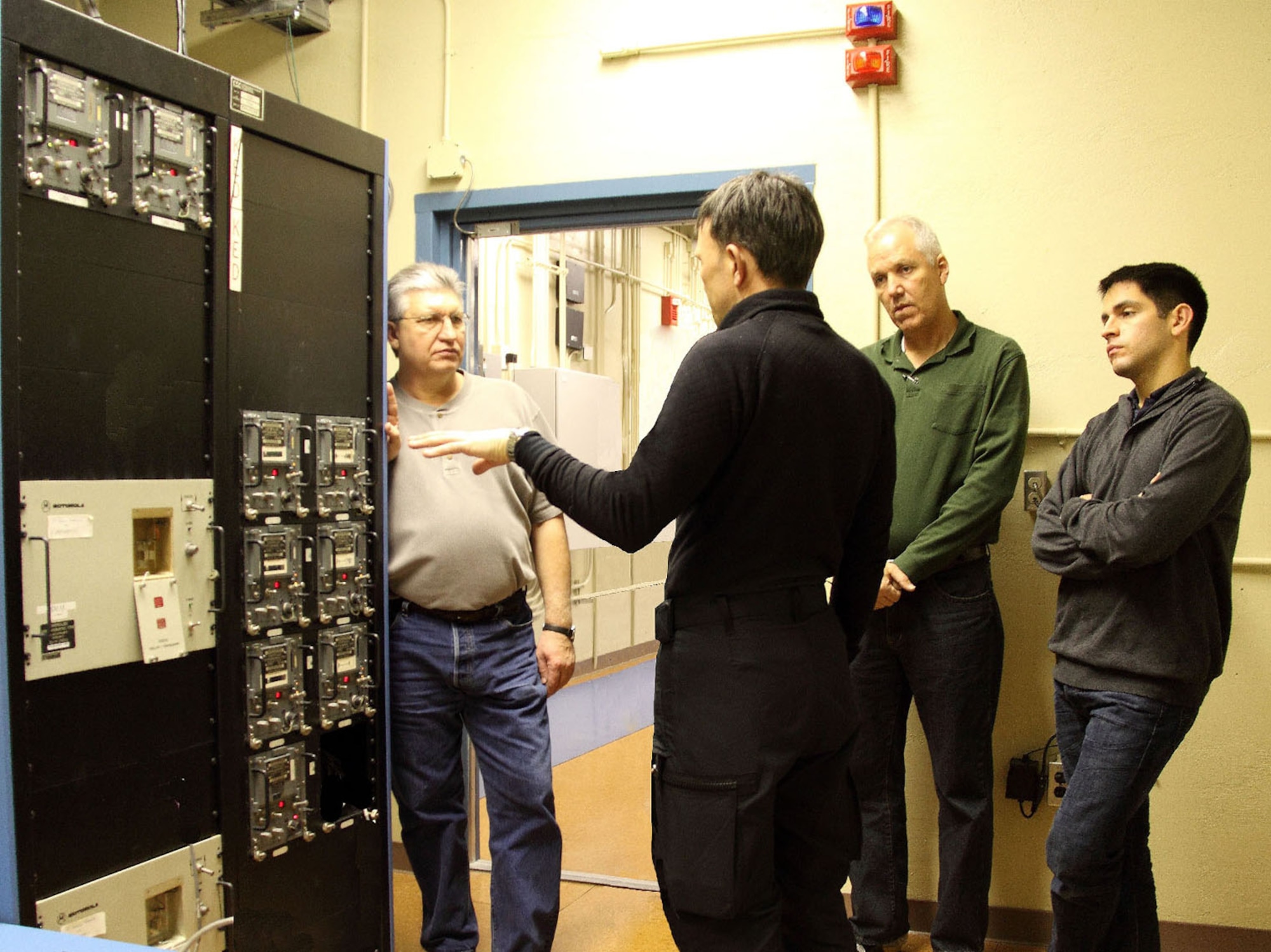 Björgvin Ingimarsson of the Iceland Coast Guard (foreground), troubleshoots issues with Cryptologic Systems Division members (from left to right) James McCarty, James Barnett and Ronald Garcia Jr., on critical communication security equipment at a remote Iceland site. The CPSD team was instrumental in getting the equipment back up and running after it had fallen into a state of disuse. (Photo courtesy of James McCarty)