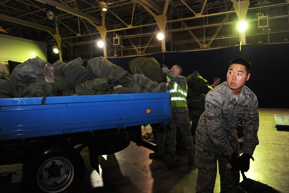 U.S. Air Force Airman Tae Kang, 35th Logistics Readiness Squadron augmentee, loads baggage onto a truck during an operational readiness exercise at Misawa Air Base, Japan, April 27, 2012. Airmen at Misawa participate in exercises to maintain their operational readiness capabilities. (U.S. Air Force photo by Airman 1st Class Kia Atkins/Released)