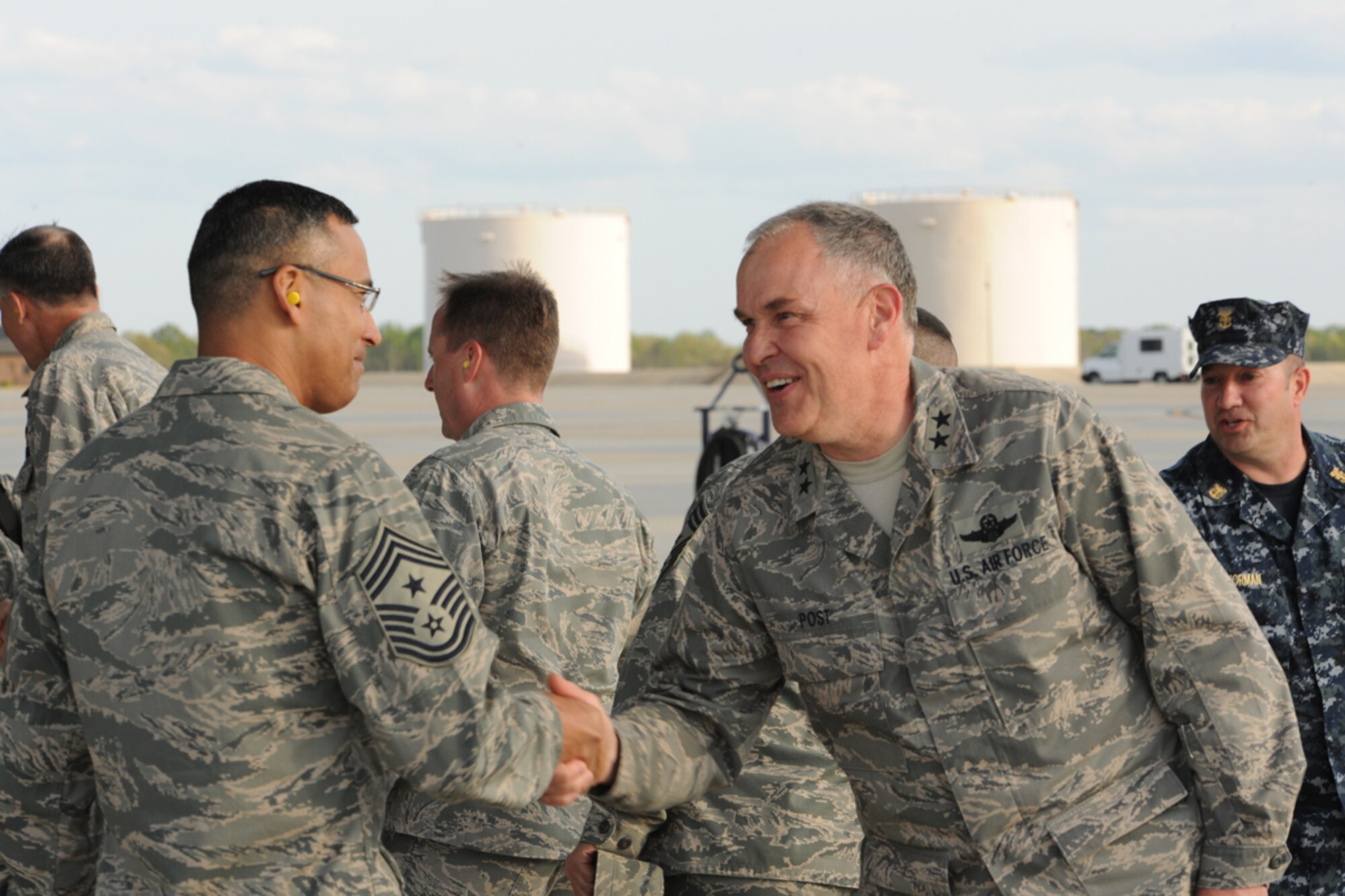 Maj. Gen. David Post, U.S. Transportation Command, greets Chief Master Sgt. Terrence Greene, 87th Air Base Wing command chief master sergeant, after arriving for a U.S. Transportation Command conference April 24 at Joint Base McGuire-Dix-Lakehurst, N.J. Gen. William Fraser, U.S. TRANSCOM commander, was accompanied by other senior joint service flag officers for a TRANSCOM conference at JB MDL. (U.S. Air Force photo by Tech. Sgt. Zachary Wilson/Released)