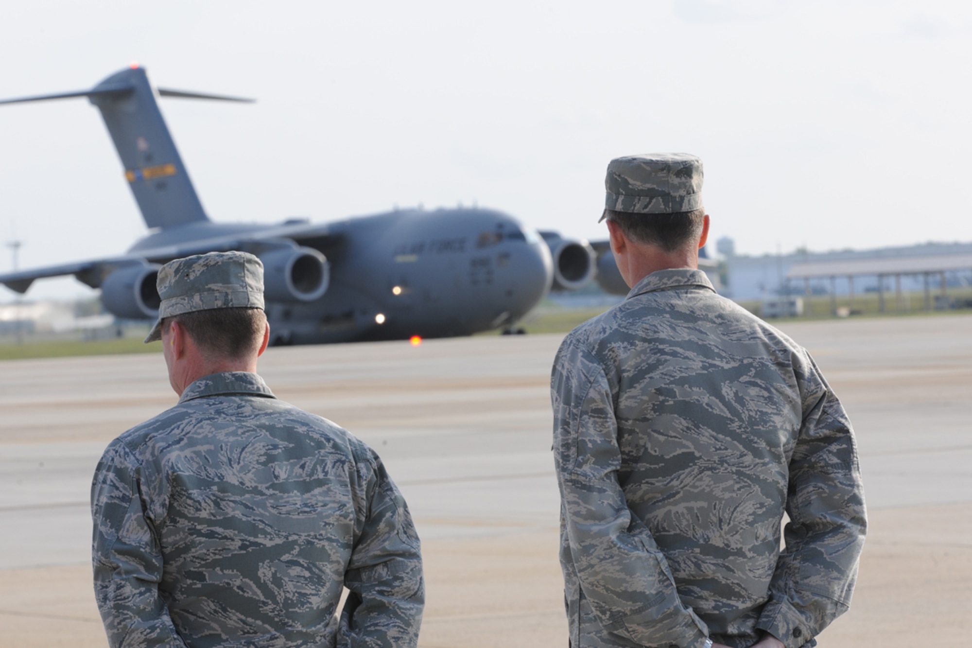 Maj. Gen. Bill Bender (right), U.S. Air Force Expeditionary Center commander and Col. John Wood (left), 87th Air Base Wing commander, await a C-17 carrying disinguished visitors from U.S. Transportation Command April 24 at Joint Base McGuire-Dix-Lakehurst, N.J. Gen. William Fraser, U.S. TRANSCOM commander, was accompanied by other senior joint service flag officers for a TRANSCOM conference at JB MDL. (U.S. Air Force photo by Tech. Sgt. Zachary Wilson/Released)