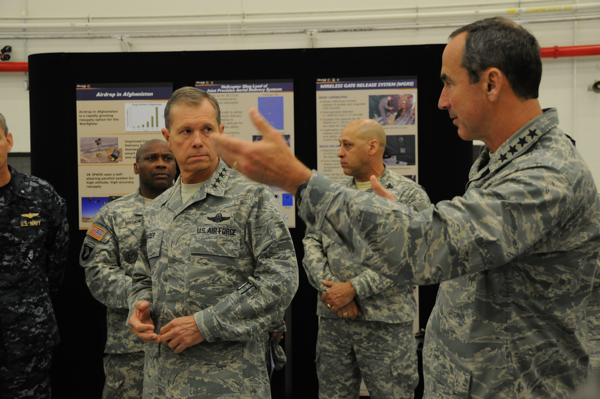 Gen. Raymond Johns, Air Mobility Command commander, (right), explains new concepts in aerial delivery systems to Gen. William Fraser, U.S. Transportation Command commander April 25 at Joint Base McGuire-Dix-Lakehurst, N.J. The generals were joined by other senior flag officers from USTRANSCOM for a joint conference at JB MDL. (U.S. Air Force photo by Tech. Sgt. Nathan Bevier/Released)