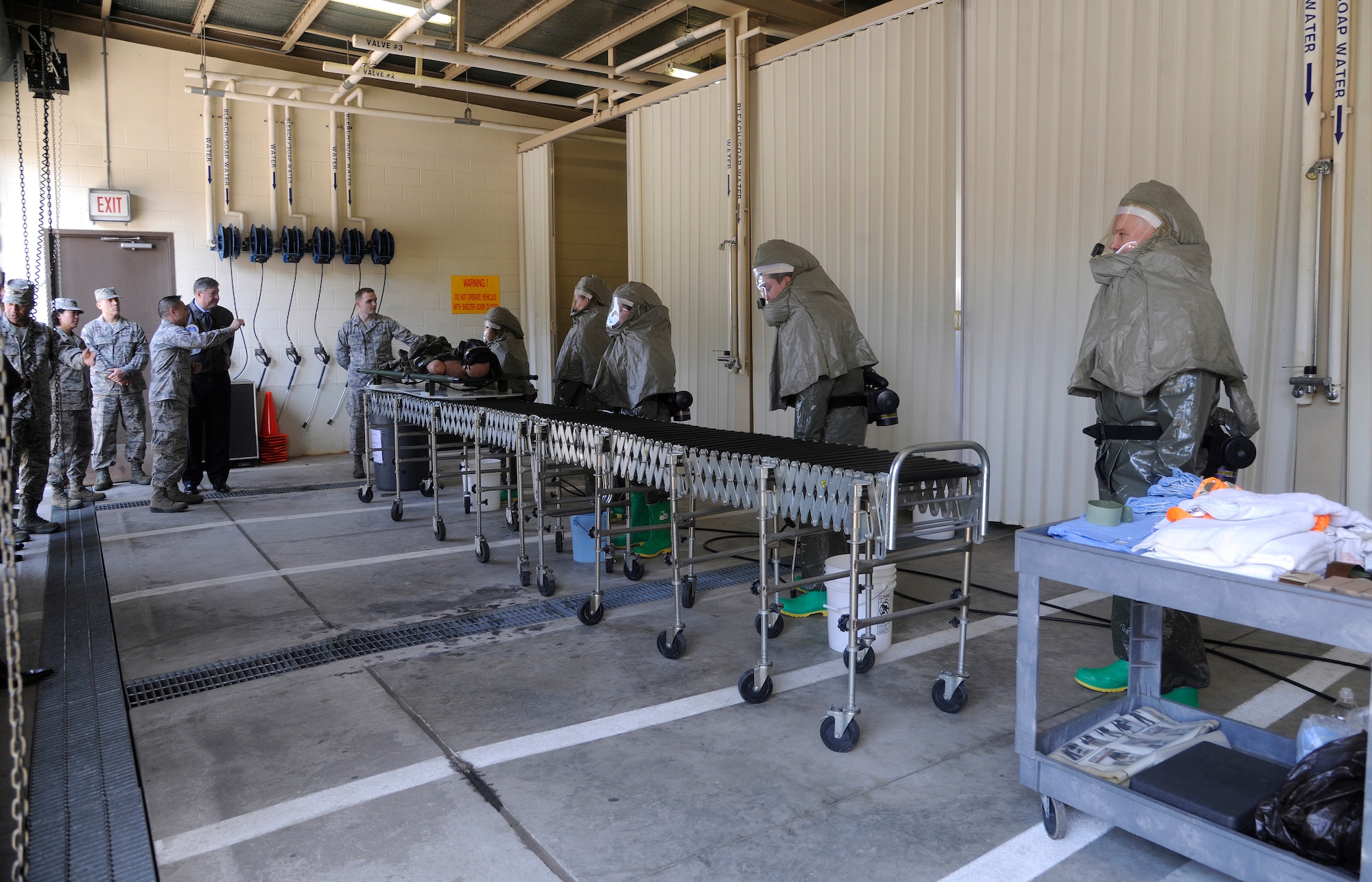 Airmen from the 8th Medical Group perform a decontamination demonstration for Secretary of the Air Force Michael Donley during his trip to Kunsan Air Base, Republic of Korea, April 27, 2012. The secretary toured various facilities throughout Kunsan AB during his visit. (U.S. Air Force photo/Staff Sgt. Rasheen A. Douglas)