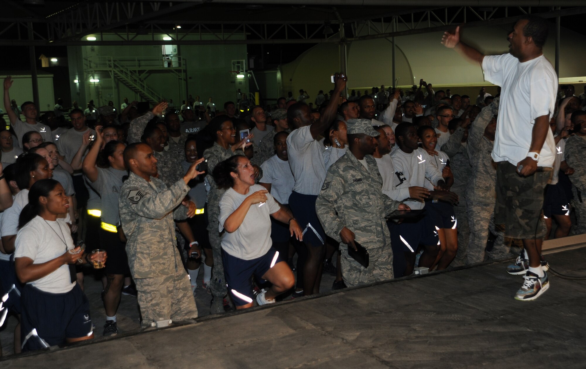 SOUTHWEST ASIA - Members of the 380th Air Expeditionary Wing dance while famed entertainer DJ Jazzy Jeff?s emcee, Skillz (right), pumps up the crowd April 25, 2012. This was first time DJ Jazzy Jeff performed for military members and after playing for more than an hour, he and his emcee took pictures and signed autographs. (U.S. Air Force photo/Staff Sgt. J.G. Buzanowski)