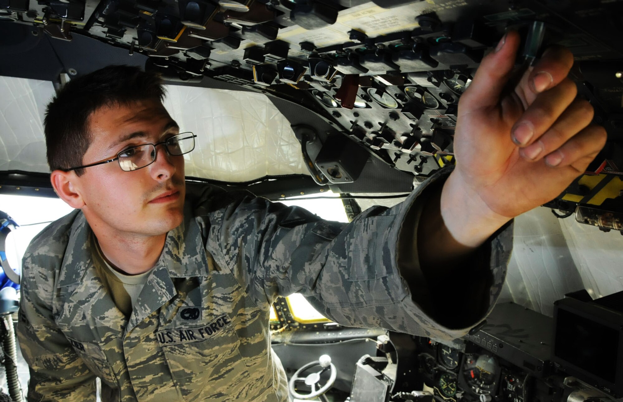 U.S. Air Force Airman 1st Class Brandon Zier, 386th Expeditionary Aircraft Maintenance Squadron electrical and environmental technician, goes through the pre-external power checklist on the Lockheed C-130 Hercules at an undisclosed location, Southwest Asia, April 18, 2012. Zier is a native of San Antonio, Texas and is deployed from the 374th Maintenance Squadron, Yokota Air Base, Japan. (U.S. Air Force photo by Staff Sgt. James Lieth)