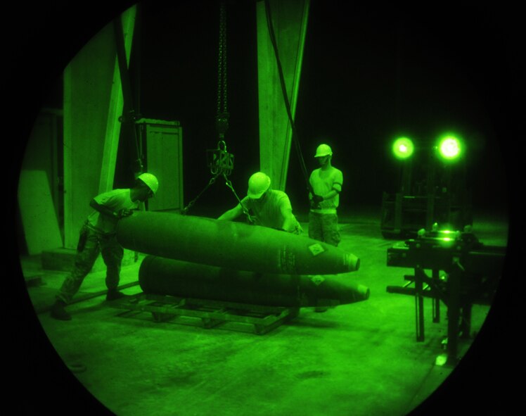 ANDERSEN AIR FORCE BASE, Guam—Airmen from the 36th Munitions Squadron place bombs on a rack during the Combat Ammunition Production Exercise April 25. Members from the 36 MUNS built munitions through the night to support the CAPEX mission. (U.S. Air Force photo by Senior Airman Benjamin Wiseman/Released)