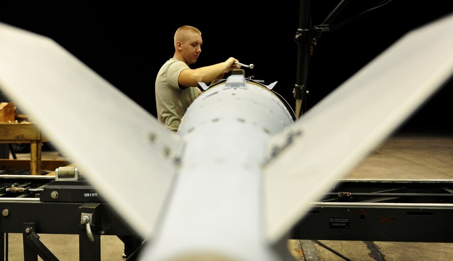 ANDERSEN AIR FORCE BASE, Guam—An Airman From the 36th Munitions Squadron puts the finishing touches on a built guided bomb unit during the Combat Ammunition Production Exercise April 25. Several 36 MUNS Airmen worked night shifts to showcase the bases full capabilities during the exercise. (U.S. Air Force photo by Senior Airman Benjamin Wiseman/Released)