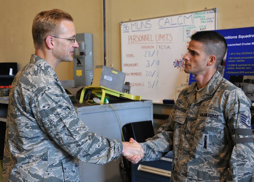 ANDERSEN AIR FORCE BASE, Guam—Brig. Gen. Mark McLeod, Pacific Air Force Headquarters director of logistics, presents a coin to Staff Sgt. Peter Pleasanton, 36th Munitions Squadron, for his hard work April 23. General McLeod visited several facilities as well as the Combat Ammunition Production Exercise. (U.S. Air Force photo by Senior Airman Benjamin Wiseman/Released)