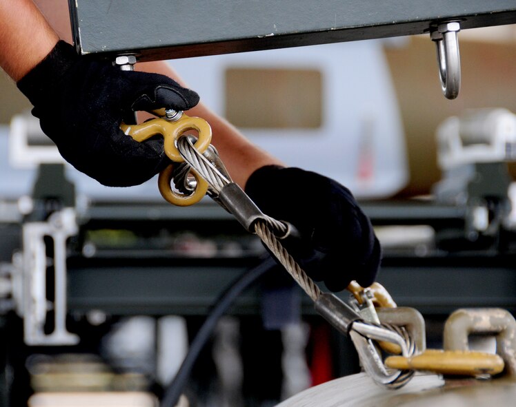 ANDERSEN AIR FORCE BASE, Guam- An Airman from the 36th Munitions Squadron prepares a Mark 84 bomb for transport  during the Combat Ammunition Production Exercise April 24.  CAPEX tests the 36 MUNS munitions production capabilities under possible real world scenarios. (U.S. Air Force photo by Senior Airman Jeffrey Schultze)  