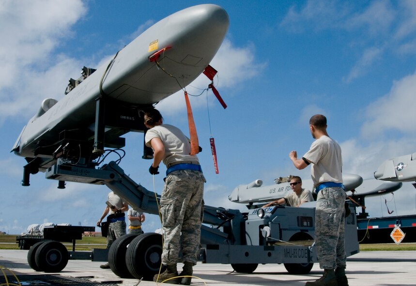 ANDERSEN AIR FORCE BASE, Guam –Airmen Deployed to the 36th Expeditionary Aircraft Maintenance Squadron, lift, inspect and transport a training Conventional Air-Launched Cruise Missile during the Combat Ammunition Production Exercise, Andersen Air Force Base, Guam, April 23, 2012. During the CAPEX approximately 21 inspectors will evaluate the processes and procedures for building munitions to support the wing’s operational plan. (U.S. Air Force photo by Staff Sgt. Alexandre Montes)