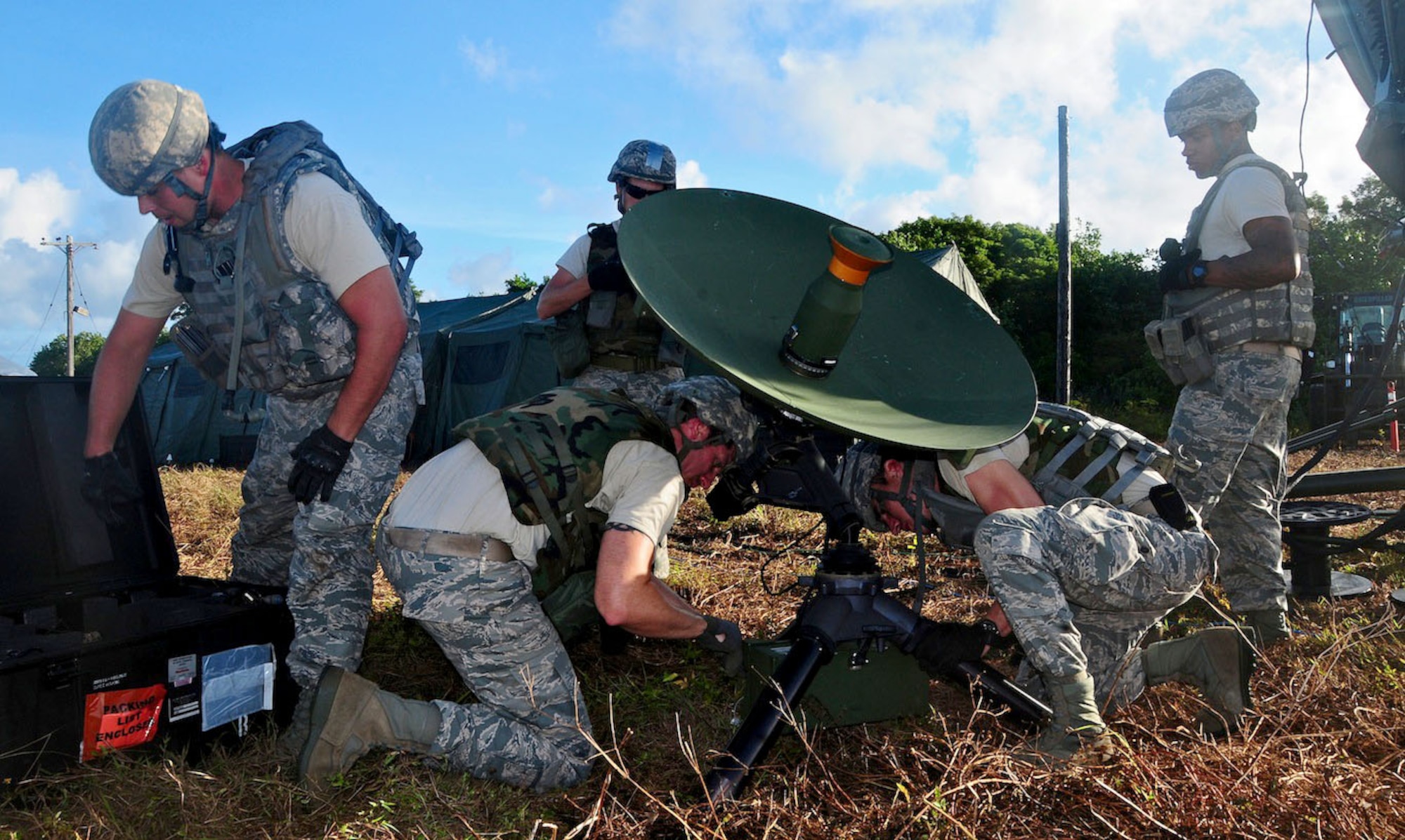 ANDERSEN AIR FORCE BASE, Guam--The 644th Combat Communications Squadron Airmen set up a satellite dish that allows the team to be current with the latest world events during Exercise Dragon Thunder April 21. Satellite transmission is the main source of communication and information in a deployed environment. (U.S. Air Force photo by Airman 1st Class Marianique Santos)