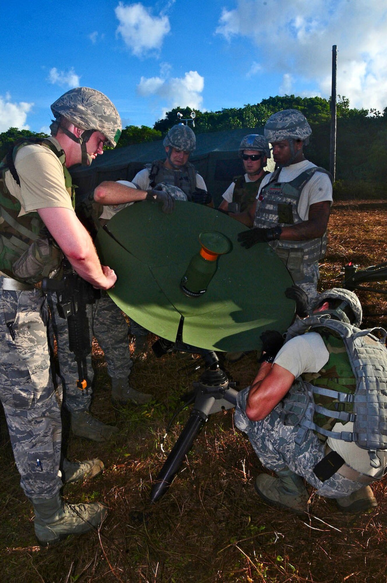 ANDERSEN AIR FORCE BASE, Guam--The 644th Combat Communications Squadron Airmen set up a satellite dish that allows the team to be current with the latest world events during Exercise Dragon Thunder April 21. Satellite transmission is the main source of communication and information in a deployed environment. (U.S. Air Force photo by Airman 1st Class Marianique Santos)