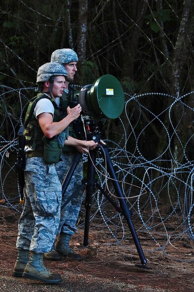 ANDERSEN AIR FORCE BASE, Guam--Tech. Sgt. Robert Chrisman, 644th Combat Communications Squadron radio frequency transmissions crew chief, moves the modulator while Staff Sgt. David Foster, 644 CBCS RF transmissions supervisor, coordinates with the communications focal point in order to establish a connection with headquarters during Exercise Dragon Thunder April 19. Satellite transmission is the main source of communication and information in a deployed environment. (U.S. Air Force photo by Airman 1st Class Marianique Santos)