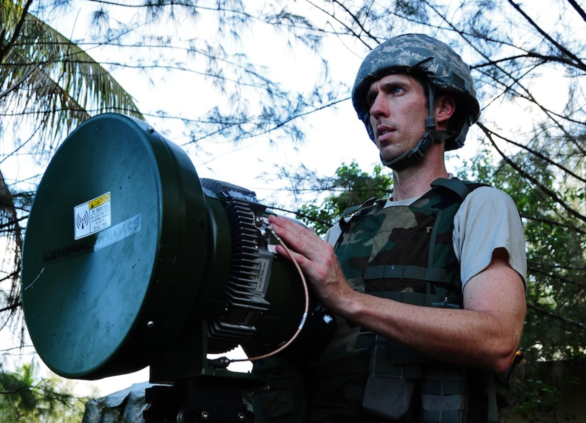 ANDERSEN AIR FORCE BASE, Guam--Tech. Sgt. Robert Chrisman, 644th Combat Communications Squadron radio frequency transmissions crew chief, moves a modulator in order to establish communication to the communications focal point tent during Exercise Dragon Thunder April 19. Satellite transmission is the main source of communication and information in a deployed environment. (U.S. Air Force photo by Airman 1st Class Marianique Santos)