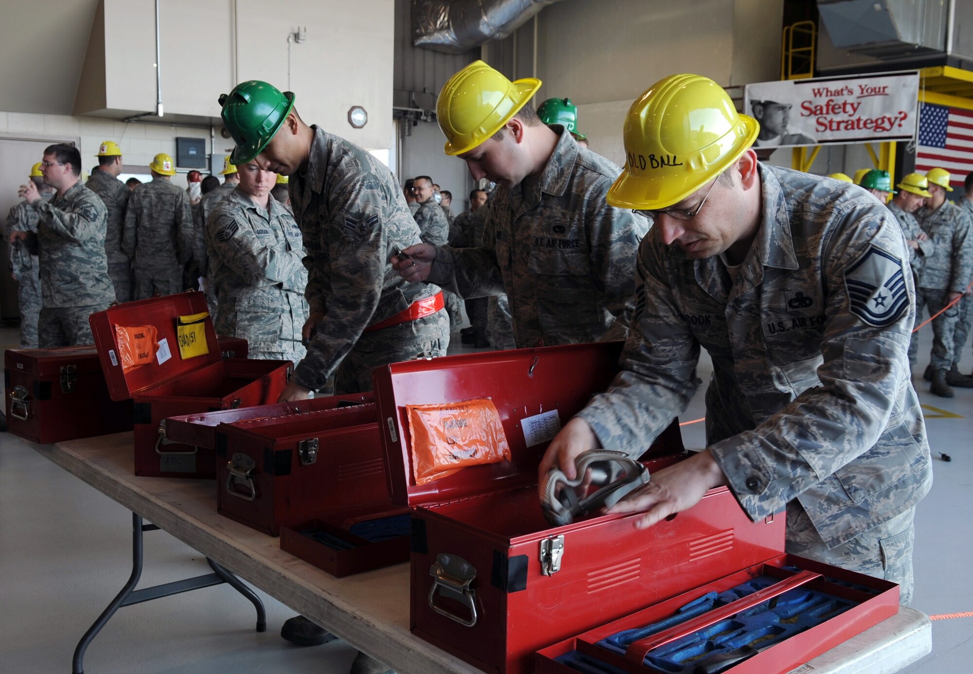U.S. Air Force Airmen from the 354th Maintenance Squadron put tools back during the composite tool kit scramble at the 354th Maintenance Group Olympics April 20, 2012, Eielson Air Force Base, Alaska. Maintainers were timed during the event to challenge their knowledge on the proper organization of tool kits. (U.S Air Force photo/ A1C Lauren-Taylor Garcia)
