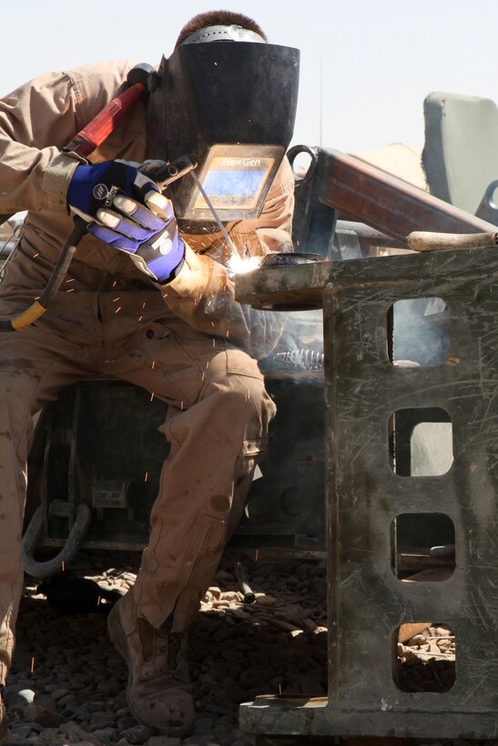 Cpl. Sean Castillo, a welder with Maintenance Company, 1st Maintenance Battalion (-) Reinforced, 1st Marine Logistics Group (Forward), puts a new weld on a section of an M1 870 trailer at the Intermediate Maintenance Lot on Camp Leatherneck, Afghanistan, April 27. The new weld is capable of supporting 110,000 pounds per square inch. Additionally, Castillo puts three times as many welds on the troubled areas to ensure the trailers can withstand Afghanistan’s rough terrain.
