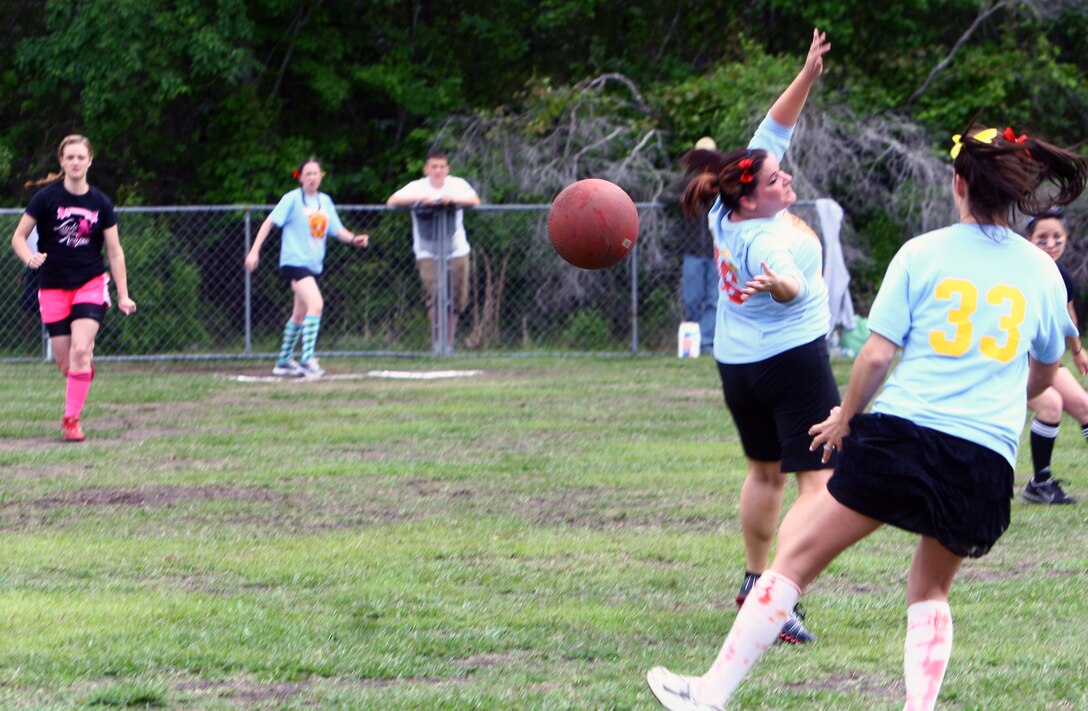 A single lands between players of the 2/9etts kickball team, representing 2nd Battalion, 9th Marine Regiment, 2nd Marine Division, during the Spouses Lejeune Area Kickball Association’s Spring Thaw Kickball Tournament.  Fifteen teams comprised of Marine and Navy spouses, mostly from 2nd Marine Division, competed in the double-elimination tournament that raised approximately $5,000 for Wounded Warrior Battalion -- East.   (Official U.S. Marine Corps photo by Cpl. Tommy Bellegarde)