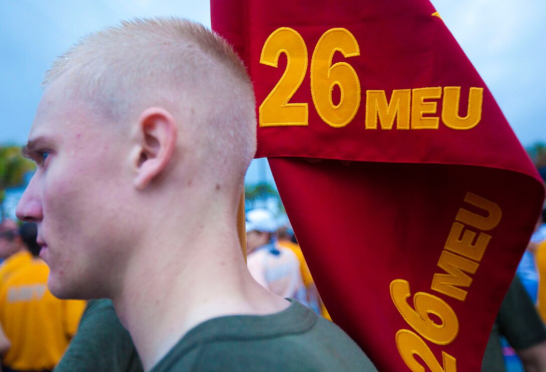 U.S. Marine Corps Lance Cpl. Ian Dangler, a 26th Marine Expeditionary Unit intelligence specialist, holds the 26th MEU guidon before before a formation run during the Fort Lauderdale Rotary U.S. Military 5K at Danai Beach, Fla., April 29, 2012.  Marines and sailors of the 26th Marine Expeditionary Unit are currently providing support to Fleet Week Port Everglades in order to showcase the strength and flexibility of today's Navy-Marine Corps team. (U.S. Marine Corps photo by Cpl. Christopher Q. Stone/Released) ::r::::n::::r::::n::::r::::n::::r::::n::::r::::n::
