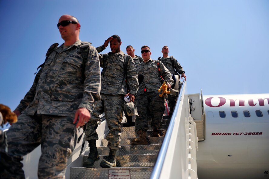 Airmen from 79th Fighter Squadron and Tiger Maintenance Unit Airmen step out of their plane after returning from a seven-month deployment at Shaw Air Force Base, S.C., April 28, 2012. The 79th Fighter Squadron flew the last two combat Air Force aircraft over Iraq providing top cover for the last convoys leaving the country. (U.S. Air Force photo by Senior Airman Daniel Phelps/Released)
