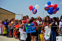 Friends and families of the 79th Fighter Squadron and Tiger Maintenance Unit Airmen wait on the flightline for their loved ones to step out of their plane after returning from a seven-month deployment at Shaw Air Force Base, S.C., April 28, 2012. The 79th Fighter Squadron flew the last two combat Air Force aircraft over Iraq providing top cover for the last convoys leaving the country. (U.S. Air Force photo by Senior Airman Daniel Phelps/Released)