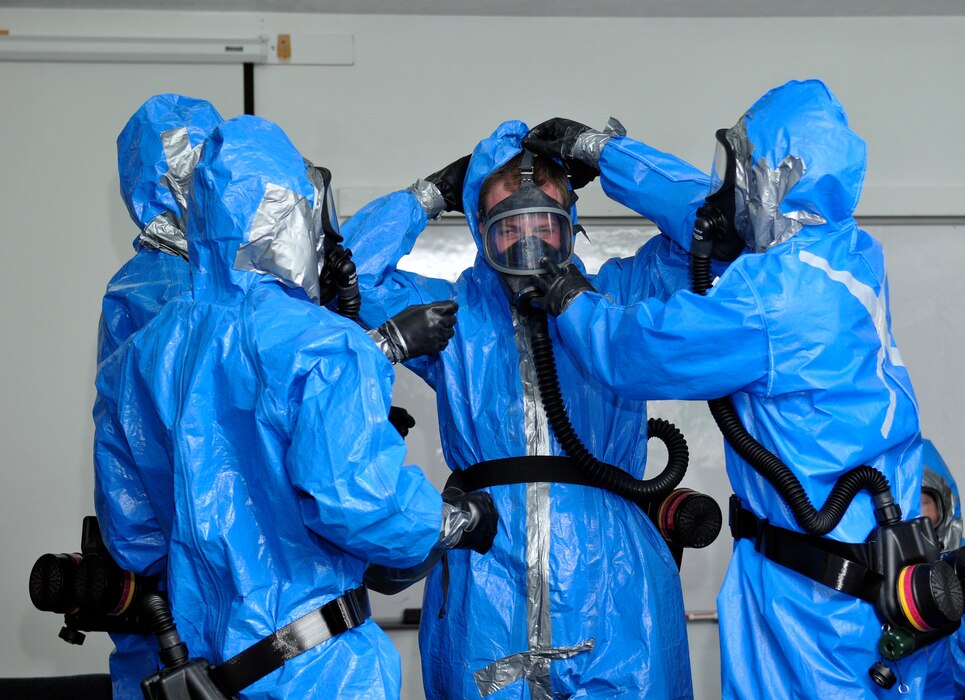 Members of the 151st Air Refueling Wing Medical Group don their hazardous material suits for training during the Great Utah Shakeout earthquake drill April 17, 2012, at Camp Williams, Utah.  (U.S. Air Force Photo by Tech. Sgt. Jeremy Giacoletto-Stegall/Released)