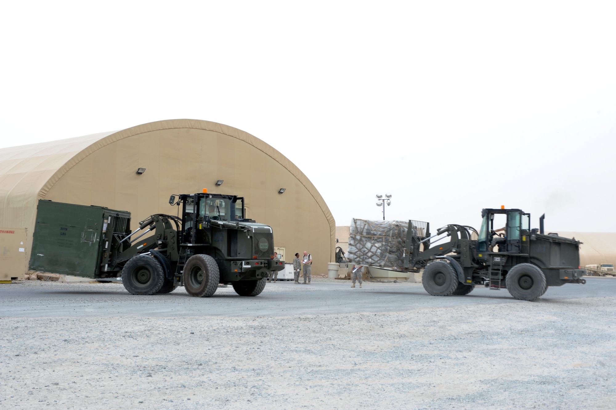 SOUTHWEST ASIA -- 386th Expeditionary Logistics Readiness Squadron vehicle operators use forklifts to place cargo in the cargo yard here, April 26, 2012. The cargo was transported from the 332nd Air Expeditionary Wing to nearby installations prior to being shipped to the United States.  (U.S. Air Force photo by Staff Sgt. Joshua J. Garcia)